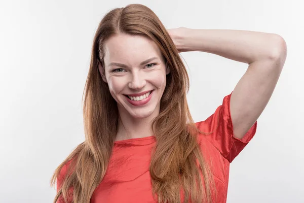 Beaming red-haired woman feeling extremely happy after getting promotion