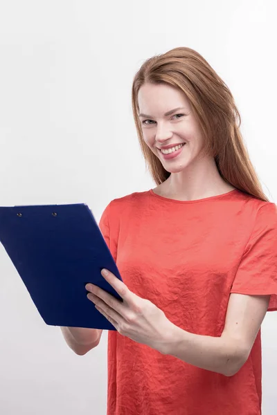 Pleasant school teacher feeling responsible while checking tests of her students — Stock Photo, Image