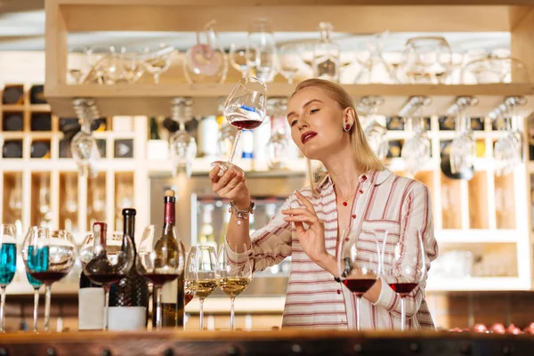 Умная привлекательная женщина, проверяющая цвет вина — стоковое фото