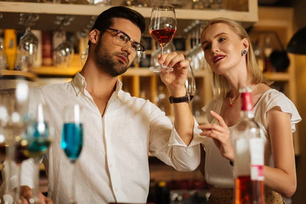 Smart nice people looking at the glass of wine — Stock Photo, Image