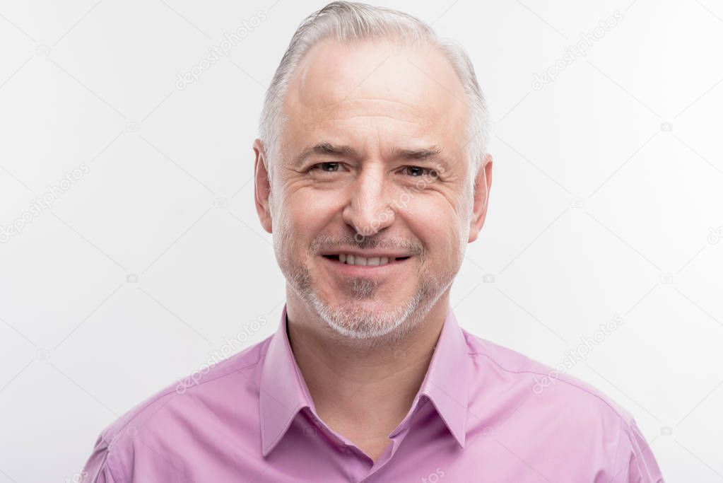 Elderly grey haired prosperous businessman smiling broadly