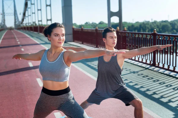 Fokuserade vacker kvinna och tränare att utforska yoga — Stockfoto