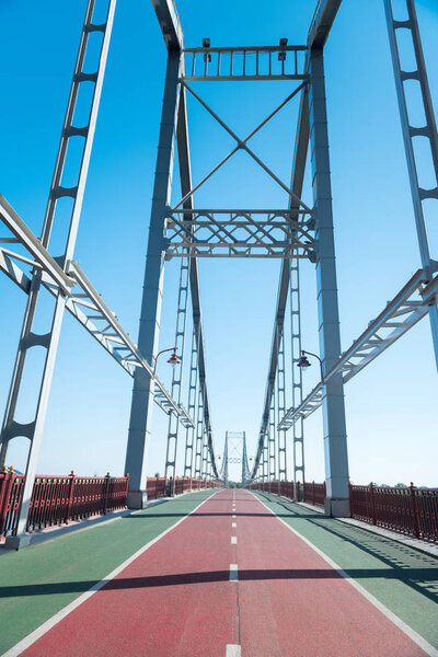 Steel urban bridge running between river banks