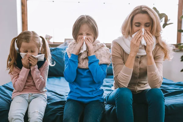 Unhappy cheerless family sneezing