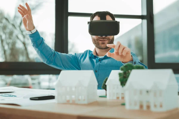 Modern workplace. Pleasant happy man wearing 3d glasses while working in the office