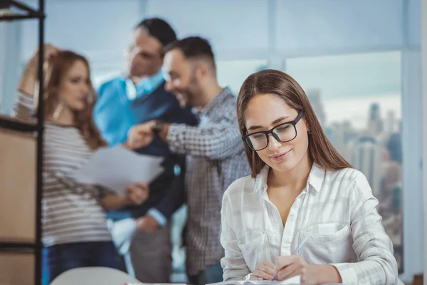 Happy female colleague writing ideas — Stock Photo, Image