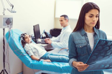 Endişeli anne inceleyerek tomografi taraması küçük kızının hesaplanan