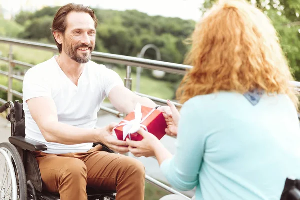 Extremely happy man giving present to his soulmate