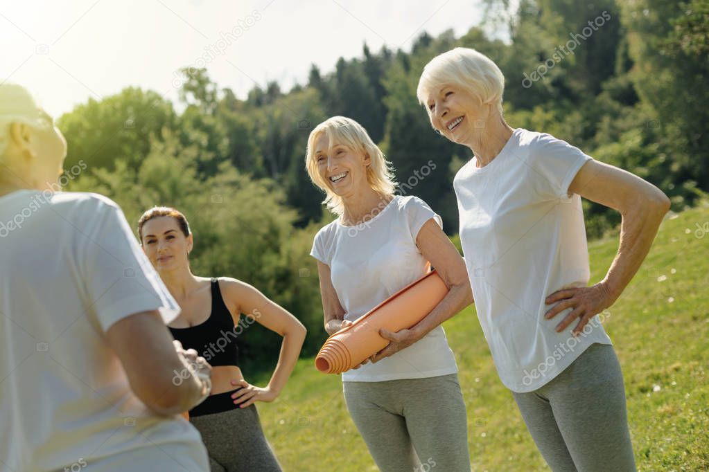 Relaxed elderly woman joking after exercising outdoors