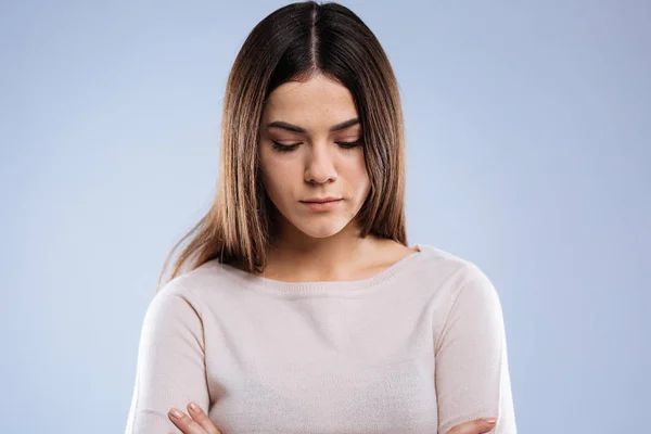 Nice young woman looking down while being sad — Stock Photo, Image