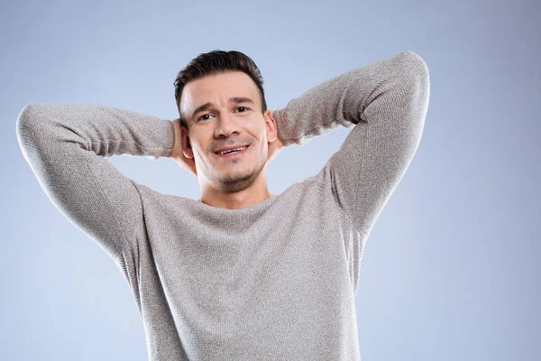 Happy positive nice man touching his head