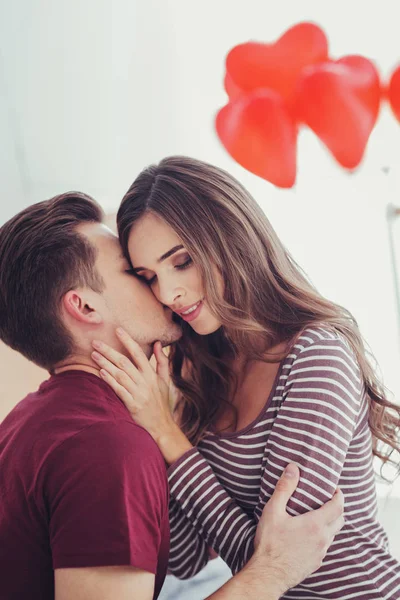 Portrait of young man kissing his amazing girlfriend — Stock Photo, Image