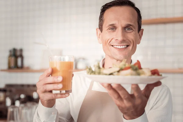 Joyful nice man holding food — Stock Photo, Image