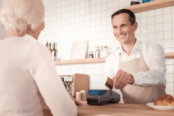 Encantado hombre alegre usando una tarjeta de crédito — Foto de Stock