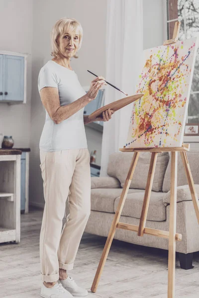 Woman wearing stylish beige trousers drawing picture — Stock Photo, Image