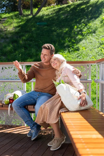 Pleased retired woman leaning on her son — Stock Photo, Image