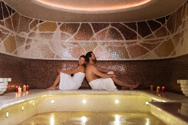 Delighted pleasant couple sitting together in sauna — Stock Photo, Image