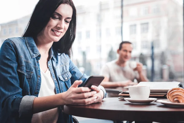 Joyful young woman chatting online