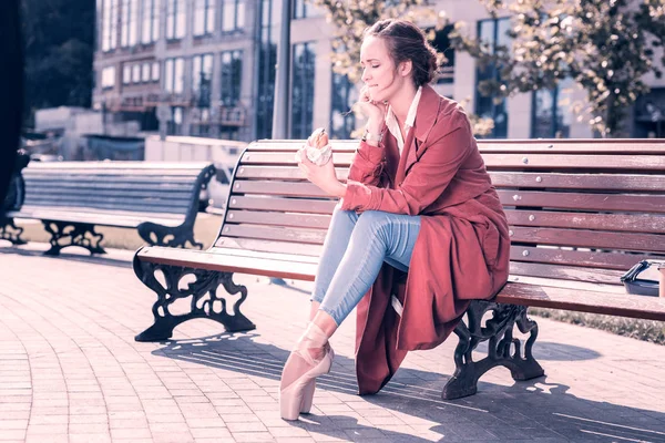 Mujer joven y agradable mirando la sabrosa hamburguesa —  Fotos de Stock