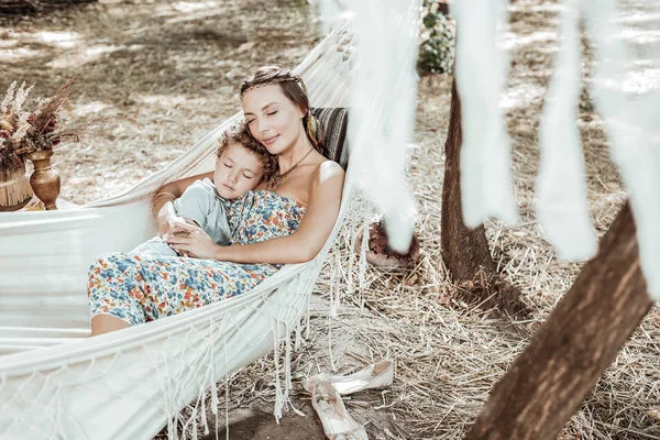 Cheerful pretty mother and child sleeping together — Stock Photo, Image
