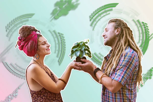 Wysokiej porywający atrakcyjny mężczyzna i kobieta przytrzymanie roślina — Zdjęcie stockowe
