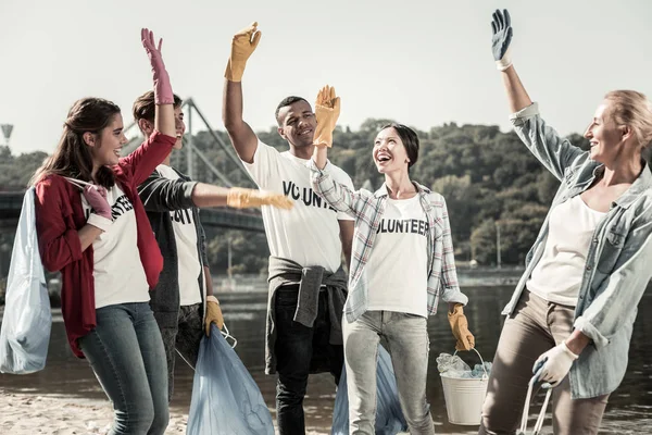 Team aktiv volontärer känsla glad och inspirerad när du arbetar tillsammans — Stockfoto