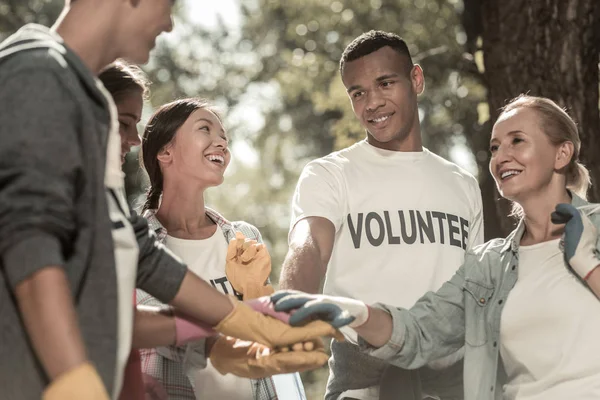 Equipo de voluntarios sintiéndose increíbles mientras trabajan juntos en el bosque verde —  Fotos de Stock