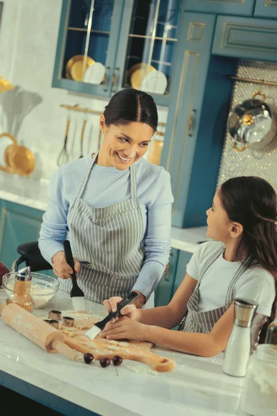 Beautiful smiling mother giving advices to her daughter