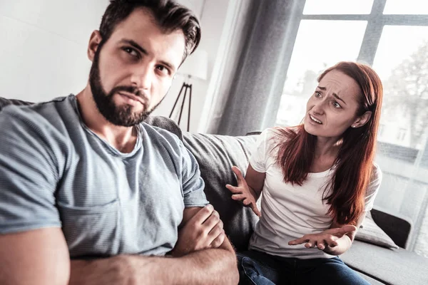 Cheerless unhappy woman talking to her husband — Stock Photo, Image