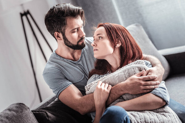 Cheerless beautiful woman looking at her boyfriend