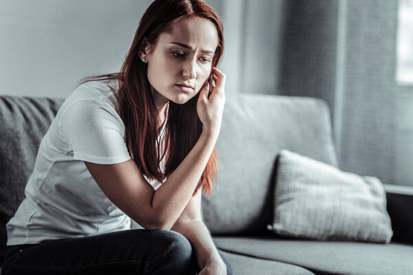 Thoughtful woman touching her hair