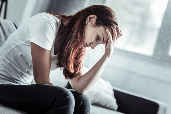 Unhappy female person having headache