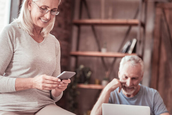 Close up of elderly couple using a mobile and a laptop