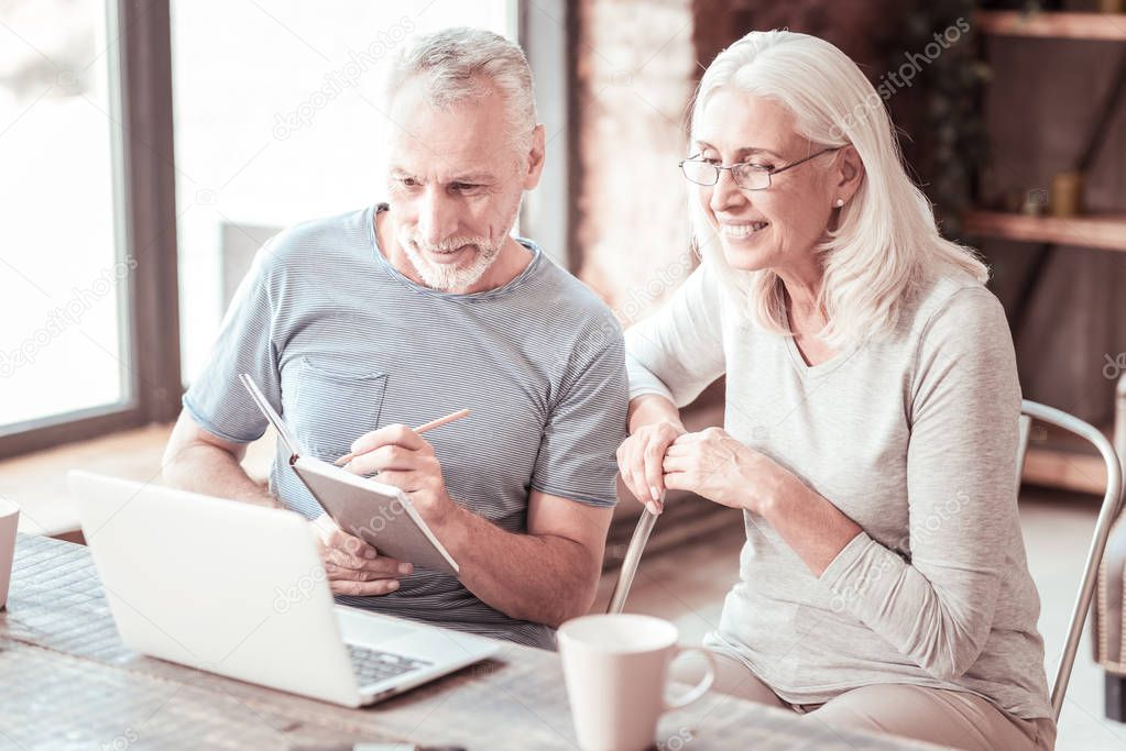 Portrait of elderly couple looking at the laptop screen