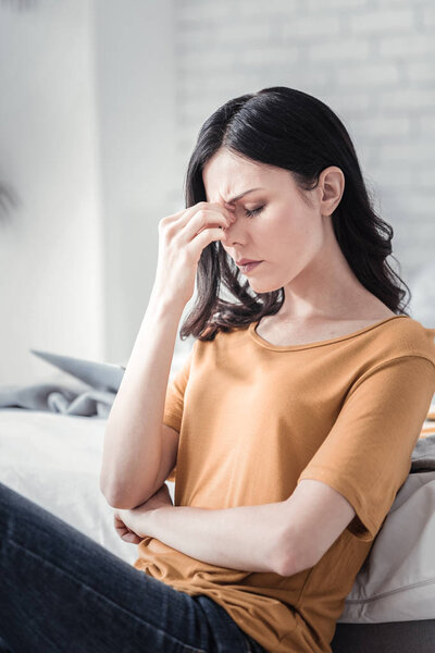 Negative delighted brunette trying to concentrate
