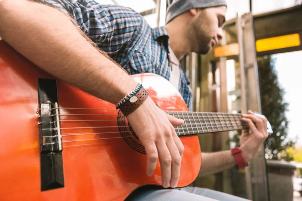 Guitarrista masculino brotando enumerando picadas na guitarra — Fotografia de Stock