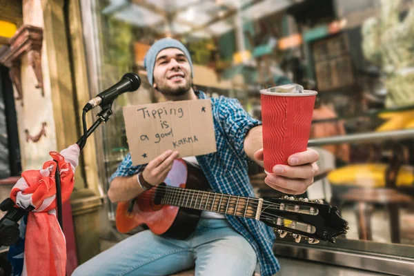 Bom músico masculino suplicando dicas após o jogo — Fotografia de Stock