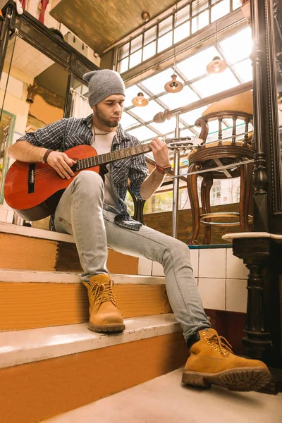 Attentive male guitarist increasing his guitar speed — Stock Photo, Image