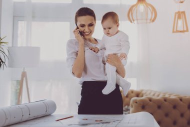 Küçük yürümeye başlayan çocuk zamanla yaparken mutlu duygu gülümseyen esmer kadın