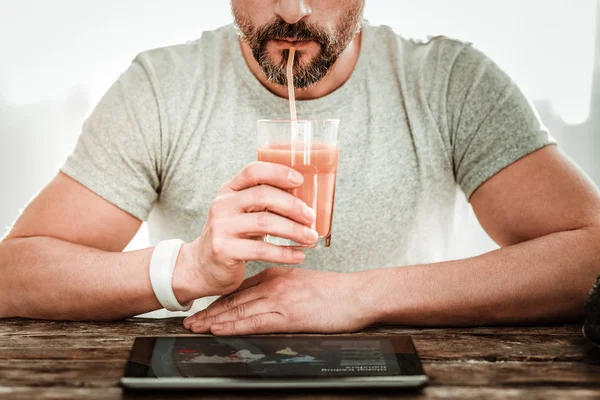 Nice pleasant man reading news the tablet — Stock Photo, Image