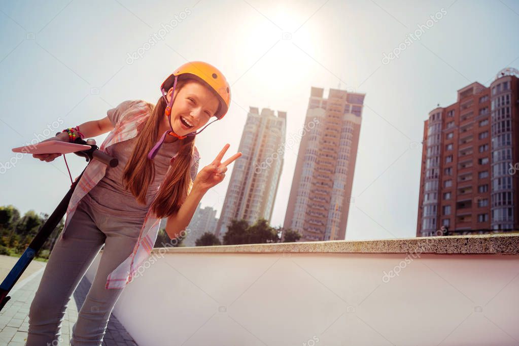 Pleased kid demonstrating her emotions on camera