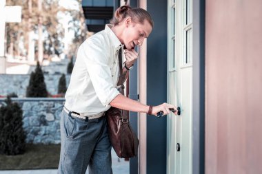 Şık adam evinin kapısını açarken anahtarları elinde tutan