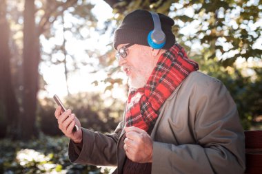 Neşeli iyi adam akıllı telefon ekrana bakarak