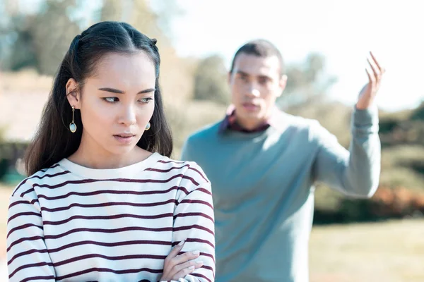 Angry young people having family quarrel in yard — Stock Photo, Image