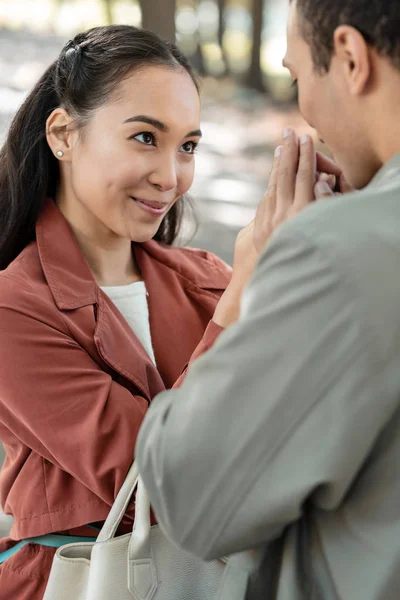 Shy international female person having date in park — Stock Photo, Image