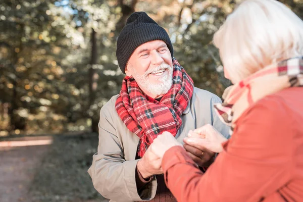 Delighted cheerful loving couple holding hands together — Stock Photo, Image