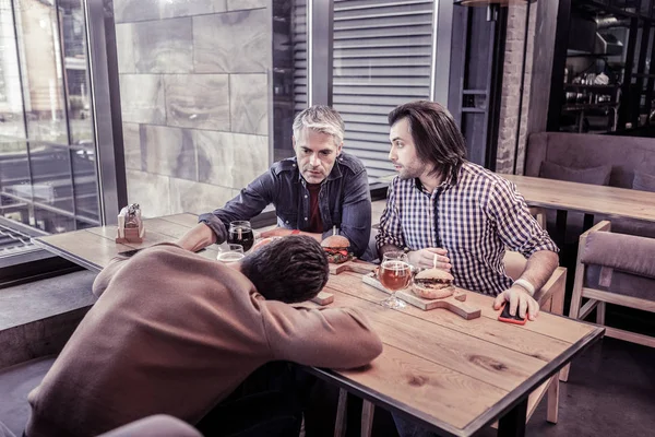 Attentive gray-haired male person calming his friend — Stock Photo, Image