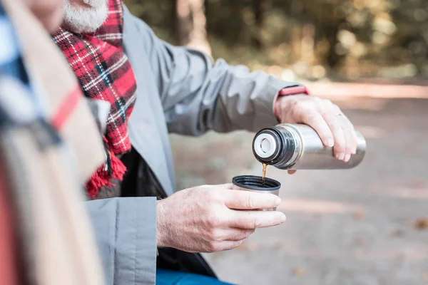 Netter angenehmer Mann, der Tee in die Tasse gießt — Stockfoto