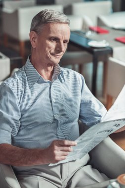 Düşünceli erkek kişi kafede Makale okuma