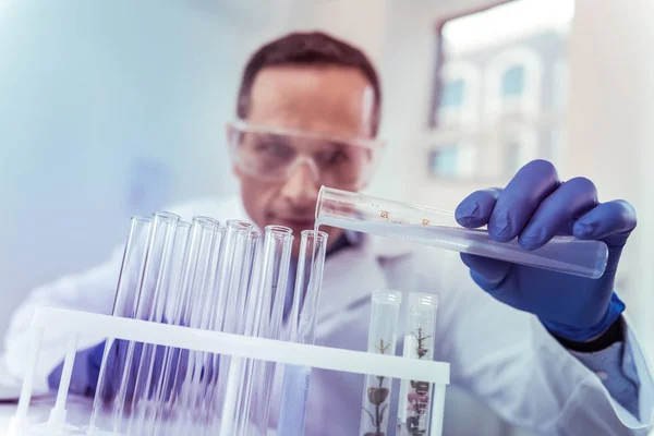 Close up of male hand that holding test tube — Stock Photo, Image